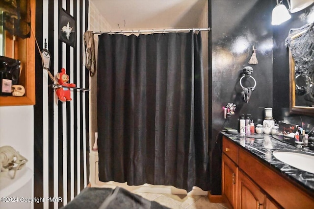 bathroom with curtained shower, tile patterned flooring, and vanity