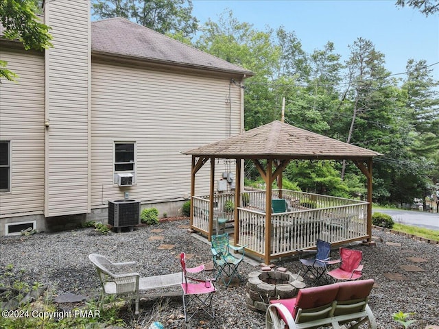 exterior space featuring cooling unit, a wooden deck, and a gazebo