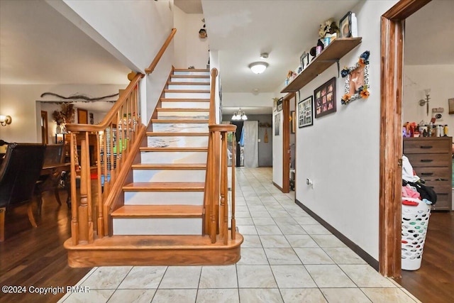 stairway featuring tile patterned flooring and baseboards