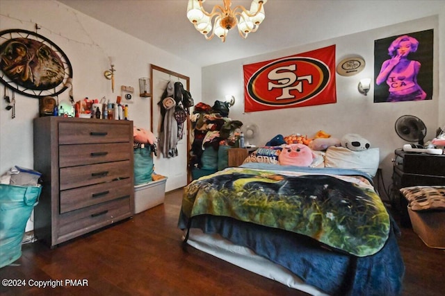 bedroom with a chandelier and wood finished floors