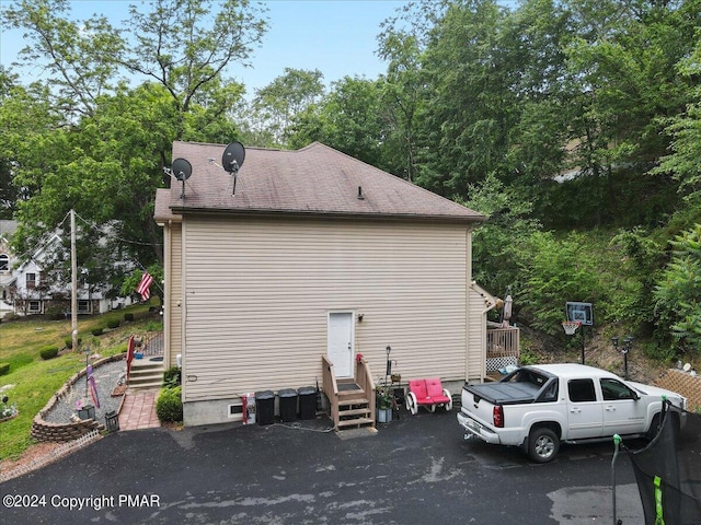 view of home's exterior with roof with shingles