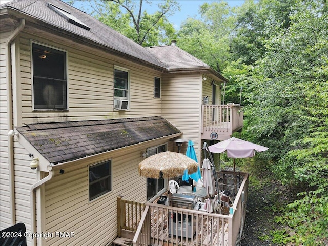 exterior space with roof with shingles