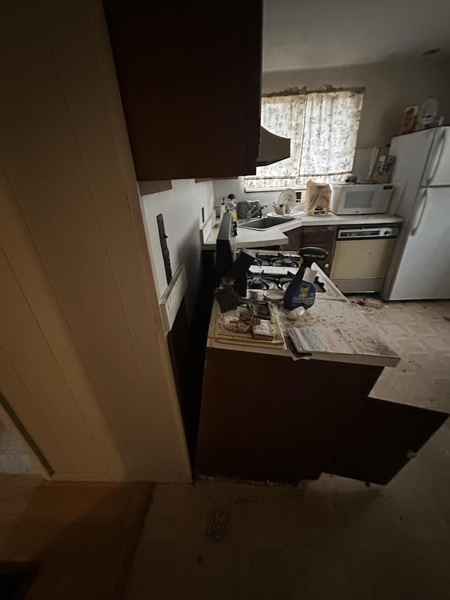 kitchen with white appliances and a sink