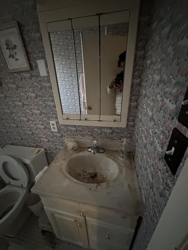 bathroom with vanity, toilet, and tile patterned floors