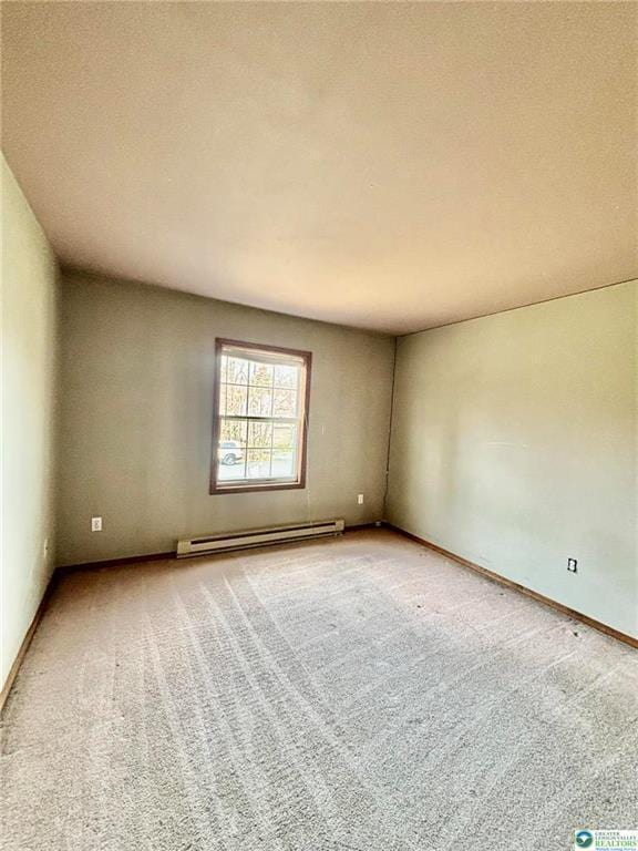 unfurnished room featuring baseboard heating, baseboards, and light colored carpet