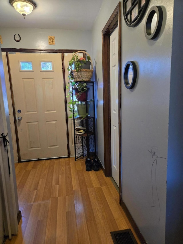 entryway with light wood-type flooring and visible vents