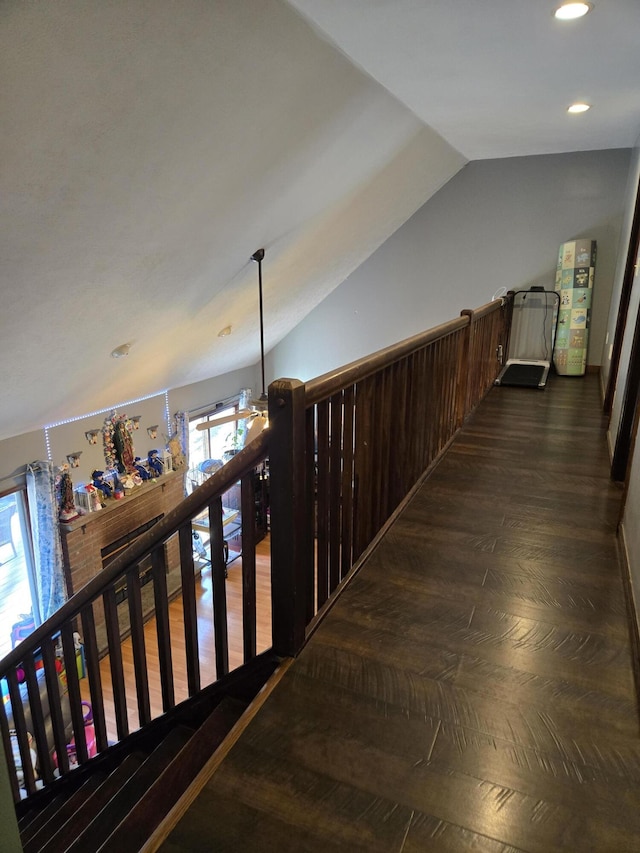 hallway featuring lofted ceiling, dark wood-style flooring, and recessed lighting