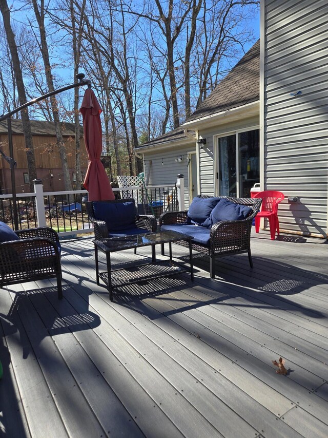 wooden deck with an outdoor living space