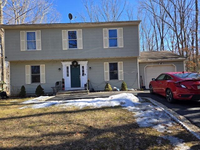 colonial-style house with a garage and driveway