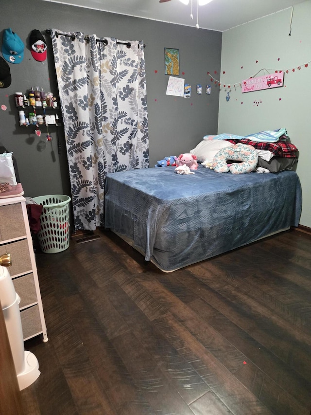 bedroom featuring a ceiling fan and wood finished floors