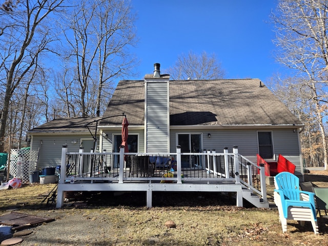 rear view of house with a chimney and a wooden deck