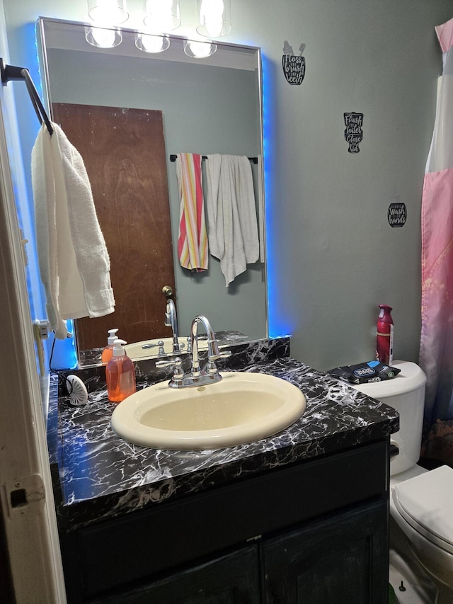 bathroom featuring toilet and vanity