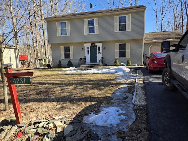 colonial home featuring a garage and driveway