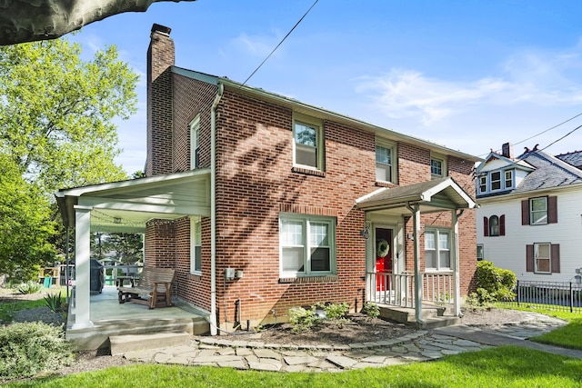 631 Main St, Tatamy, PA 18085 - view of front of house with a chimney, brick siding, and a porch