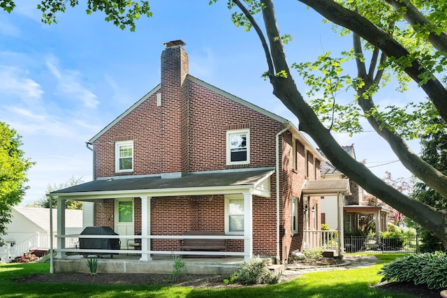 631 Main St, Tatamy, PA 18085 - back of house featuring brick siding and a chimney