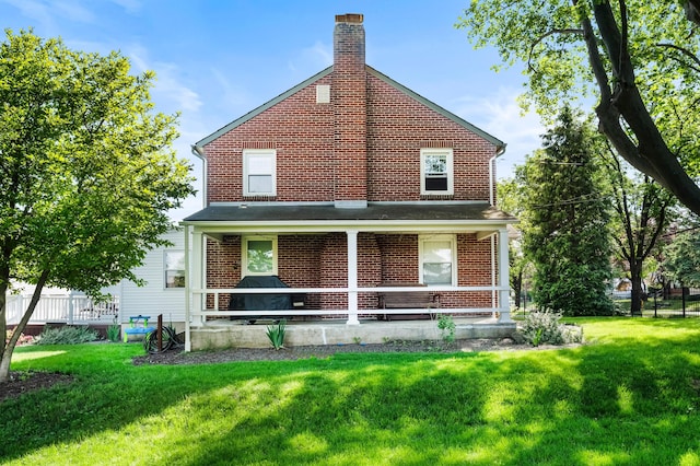 631 Main St, Tatamy, PA 18085 - back of house featuring a chimney and brick siding