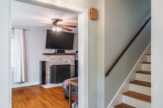 631 Main St, Tatamy, PA 18085 - stairs with ceiling fan, wood finished floors, a brick fireplace, and baseboards