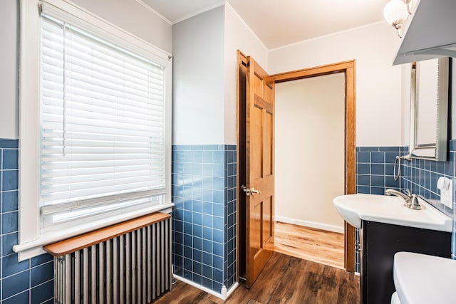 631 Main St, Tatamy, PA 18085 - bathroom featuring tile walls, radiator, wood finished floors, vanity, and crown molding