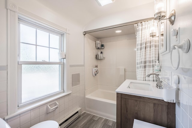 631 Main St, Tatamy, PA 18085 - full bath with a baseboard radiator, tile walls, toilet, shower / bathtub combination with curtain, and vanity
