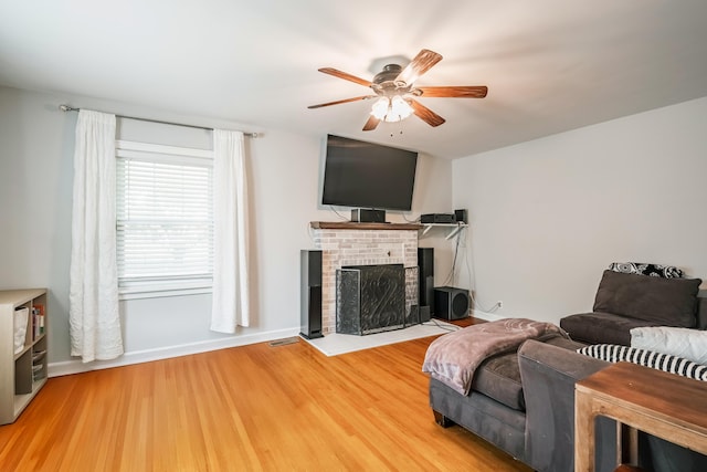 631 Main St, Tatamy, PA 18085 - living room featuring ceiling fan, a brick fireplace, wood finished floors, and baseboards