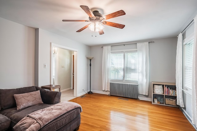 631 Main St, Tatamy, PA 18085 - living room featuring radiator, a ceiling fan, light wood-style flooring, and baseboards