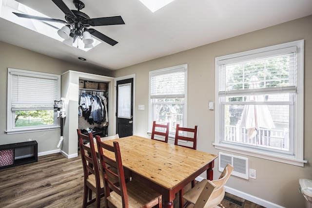 631 Main St, Tatamy, PA 18085 - dining space with dark wood finished floors, baseboards, ceiling fan, and a wall mounted AC
