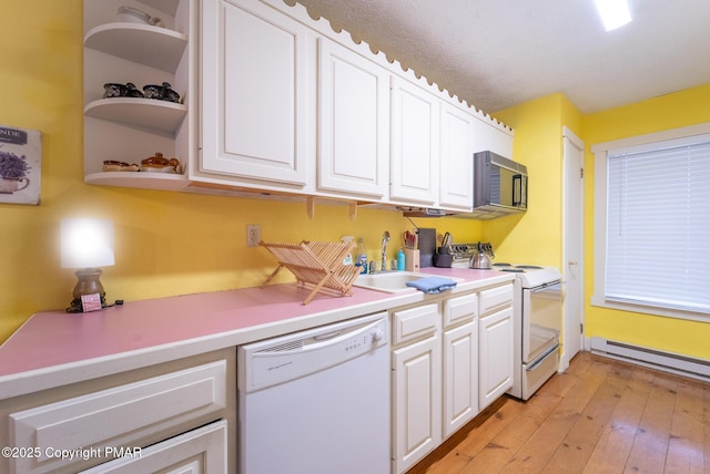 kitchen featuring white appliances, a baseboard radiator, white cabinets, and a sink