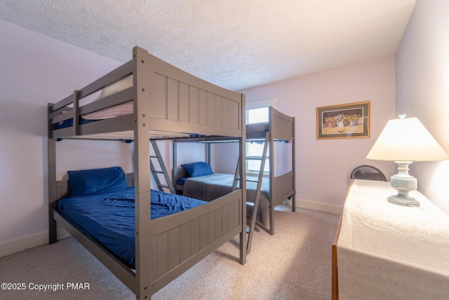 bedroom with a textured ceiling, carpet, and baseboards