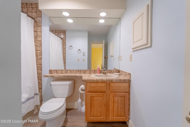 bathroom with recessed lighting, a shower with shower curtain, vanity, and toilet