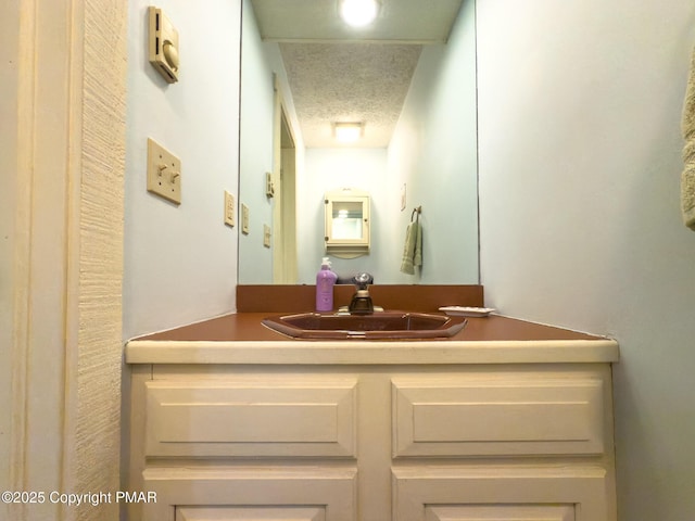 bathroom with vanity and a textured ceiling