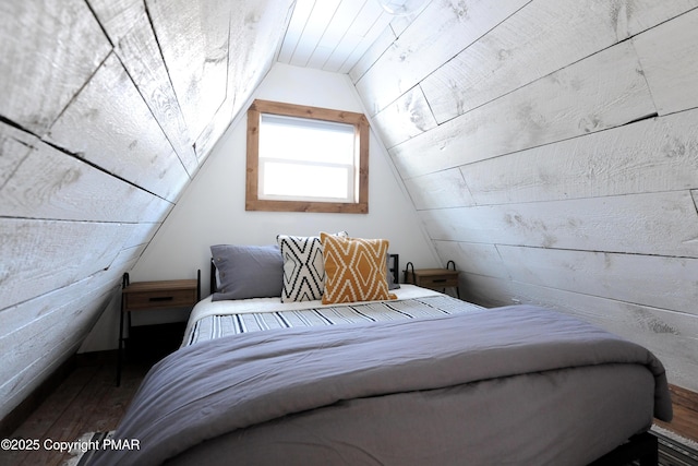 bedroom featuring wood-type flooring and vaulted ceiling