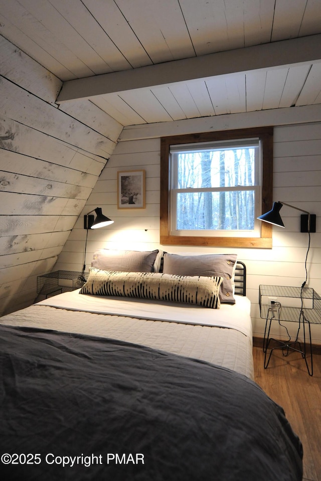 bedroom featuring vaulted ceiling with beams, hardwood / wood-style floors, wood ceiling, and wood walls