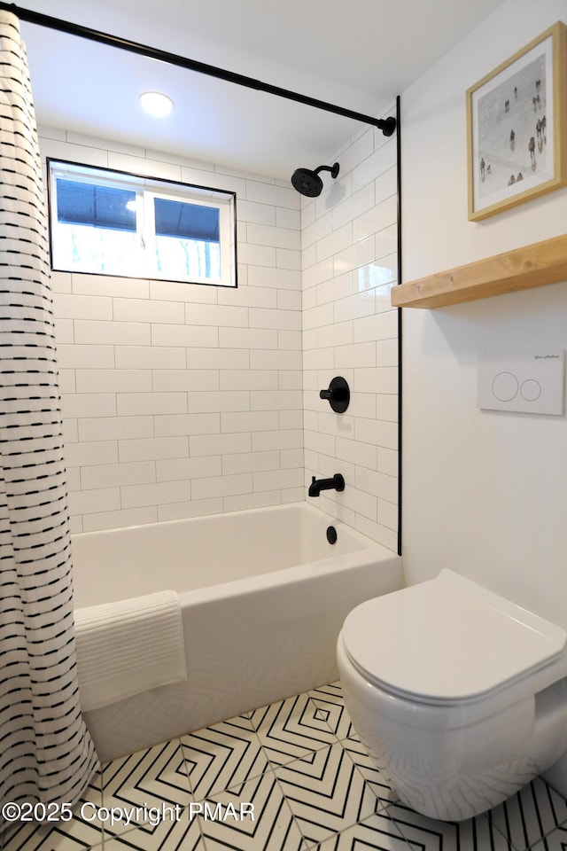 bathroom featuring tiled shower / bath combo, tile patterned floors, and toilet