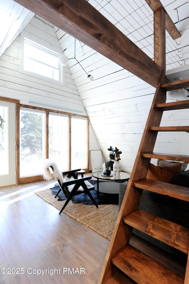 interior space with hardwood / wood-style flooring and high vaulted ceiling