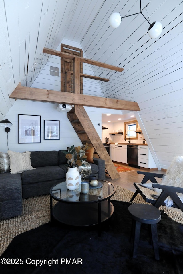 living room with wood-type flooring, high vaulted ceiling, wooden ceiling, and wood walls