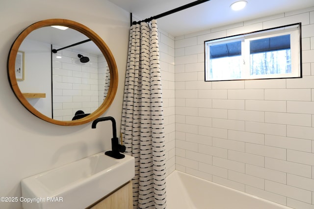 bathroom featuring sink and shower / bath combo with shower curtain