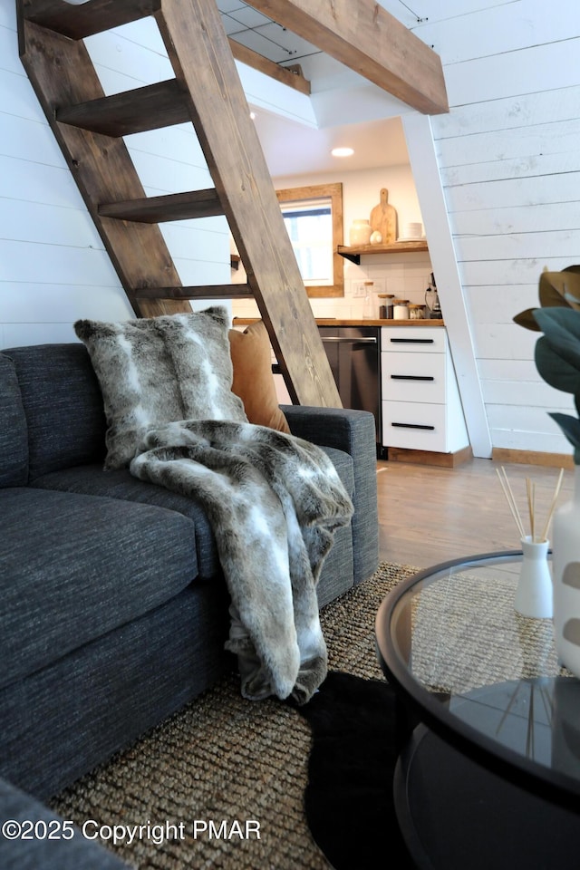 living room featuring hardwood / wood-style floors and wood walls