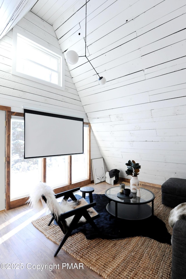 interior space featuring wood-type flooring, vaulted ceiling, wood ceiling, and wood walls