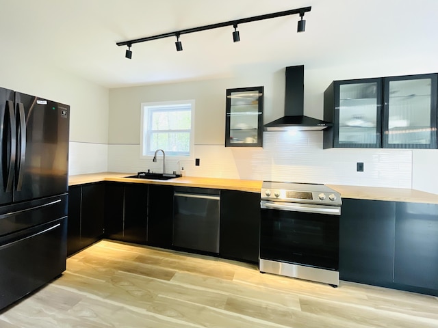 1216 Winding Way, Tobyhanna, PA 18466 - kitchen with freestanding refrigerator, wall chimney range hood, electric range, dishwashing machine, and dark cabinetry