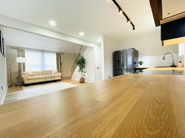1216 Winding Way, Tobyhanna, PA 18466 - kitchen featuring stainless steel fridge with ice dispenser, track lighting, tasteful backsplash, wood finished floors, and recessed lighting