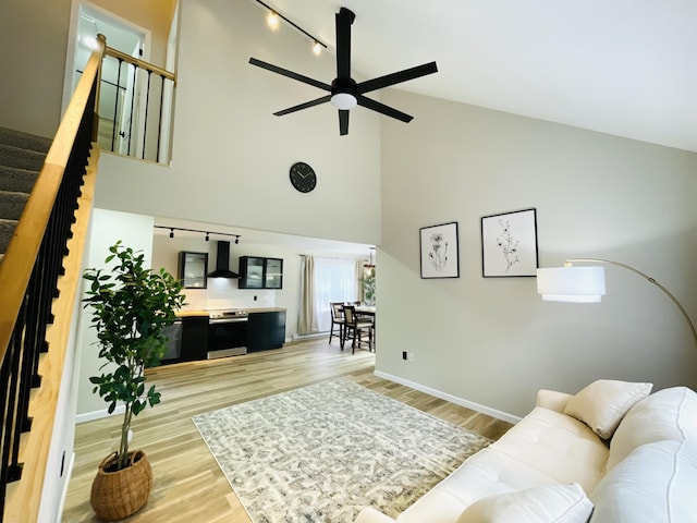 1216 Winding Way, Tobyhanna, PA 18466 - living area with a ceiling fan, high vaulted ceiling, light wood-type flooring, and stairway