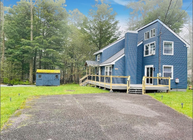 1216 Winding Way, Tobyhanna, PA 18466 - view of front of house with a storage shed, a wooden deck, and a front lawn