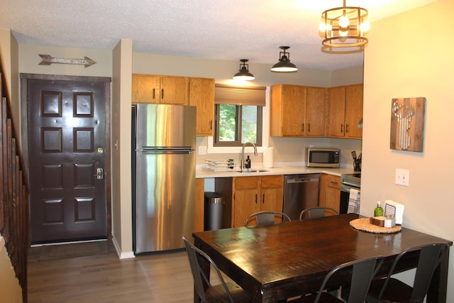 248 High Pass Way, Tannersville, PA 18372 - kitchen with stainless steel appliances, light countertops, dark wood-style flooring, a chandelier, and brown cabinetry
