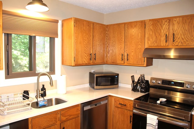 248 High Pass Way, Tannersville, PA 18372 - kitchen featuring stainless steel appliances, extractor fan, light countertops, brown cabinets, and a textured ceiling