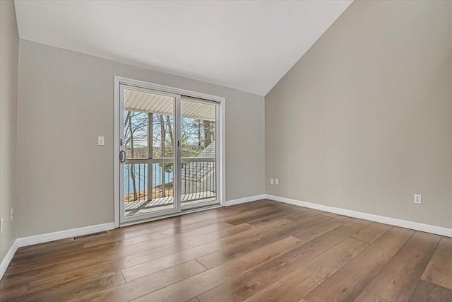 134 Laurel Hill Dr Unit 102, Greentown, PA 18426 - empty room featuring baseboards, wood-type flooring, lofted ceiling, and visible vents
