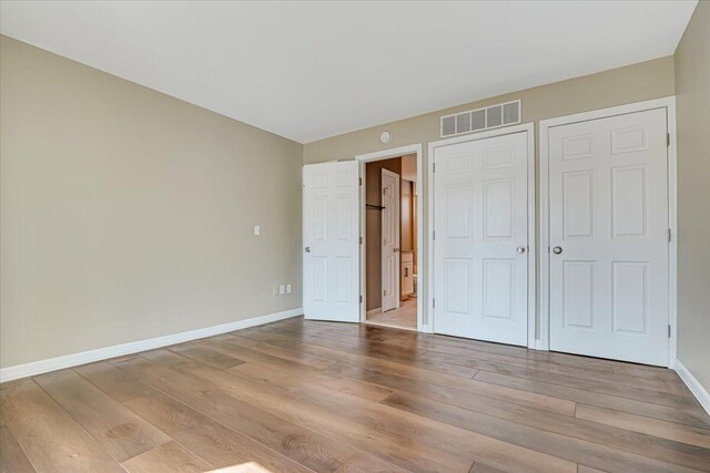 134 Laurel Hill Dr Unit 102, Greentown, PA 18426 - unfurnished bedroom with baseboards, visible vents, and wood finished floors