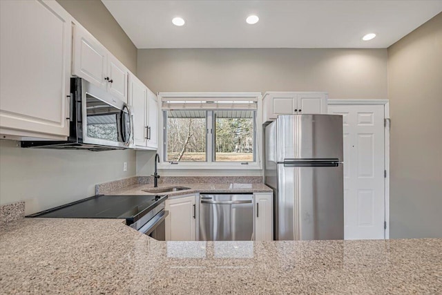 134 Laurel Hill Dr Unit 102, Greentown, PA 18426 - kitchen with recessed lighting, white cabinets, light stone counters, a sink, and stainless steel appliances