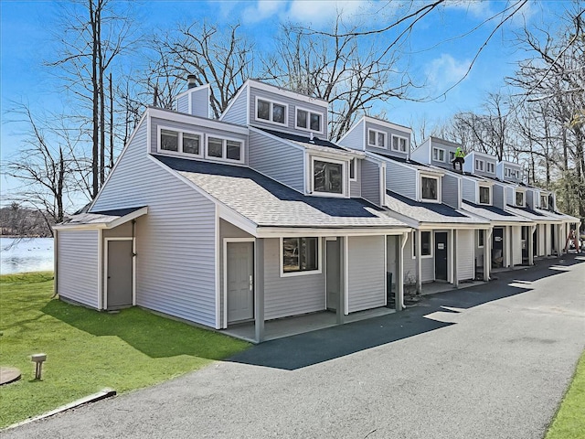 134 Laurel Hill Dr Unit 102, Greentown, PA 18426 - view of front of home with roof with shingles, a chimney, and a front yard