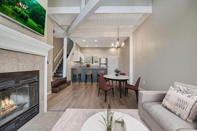 134 Laurel Hill Dr Unit 102, Greentown, PA 18426 - living room with a tiled fireplace, baseboards, beam ceiling, and a notable chandelier