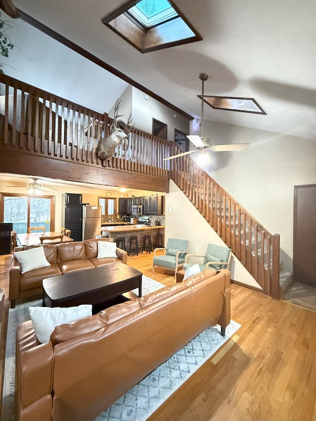 248 Penn Forest Trl, Albrightsville, PA 18210 - living room with stairs, a skylight, wood finished floors, and a ceiling fan